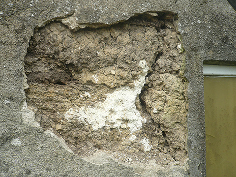 cement render delaminating from cob wall